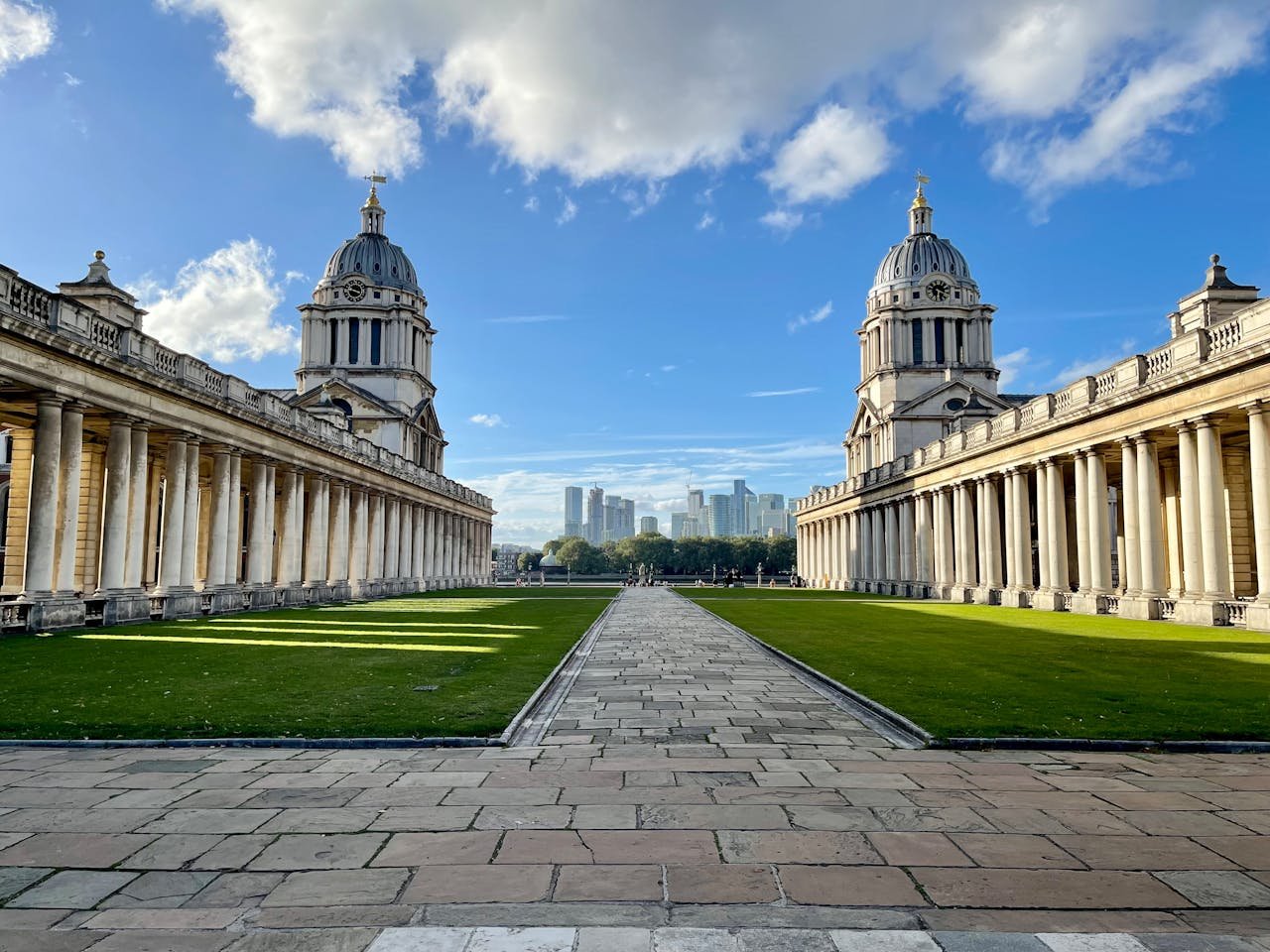 Offerings View of the Old Royal Naval College with city skyline in Greenwich, London.
