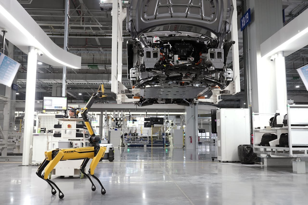The Art of Drawing Readers In: Your attractive post title goes here A robotic dog oversees an automated car assembly in a high-tech factory setting.